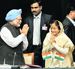 President Pratibha Patil and PM Manmohan Singh exchange greetings during a workshop at Rashtrapati Bhawan in New Delhi on Wednesday.