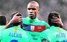 Barcelonas Eric Abidal (C), Lionel Messi (R) and Alexis Sanchez (L) celebrate a goal during their UEFA Champions League match against Bayer Leverkusen in Leverkusen on Tuesday. Barcelona won 3-1. 
