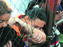 Relatives of inmates wait outside the National Prison of Comayagua