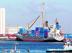 A cargo ship docks at the port of Tripoli on Thursday. Libyas oil exports are approaching pre-conflict levels and international sanctions have been lifted. But four months after fighting ended, experts warn its financial situation remains fragile