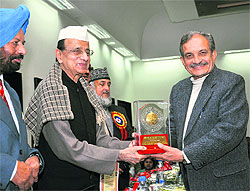 Congress leader Birender Singh being given the Bharat Jyoti Award in New Delhi on Thursday