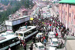 Members of the Shimla Nagrik Sabha hold a protest outside the office of the HRTC Managing Director at the bus stand in Shimla on Thursday