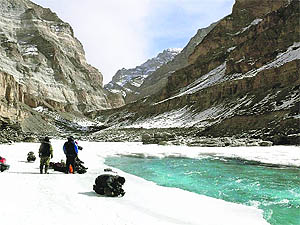 A group of trekkers takes a break on the banks of the frozen Zanskar river while undertaking the Chadar trek in Ladakh. 