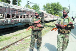 Army jawans patrol at the railway station in Jalandhar Cantonment during the curfew imposed due to violence following the Vienna incident. 