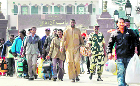 Released Indian prisoners cross over to India at the Attari-Wagah border on Thursday.