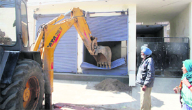An illegal structure being demolished at Tripri in Patiala.