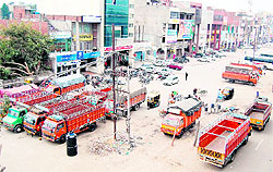 Private transporters park their trucks and buses illegally at the parking lot of City Centre, near the bus stand, in Amritsar