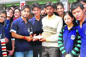 Members of Sankalp, a student-run charitable association of DAV College, Sector 10, hand over a cheque to a poor patient at the PGI in Chandigarh on Saturday. 