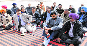 University and college teachers union members sit on a dharna at Panjab University in Chandigarh on Friday. 