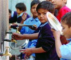 MCD school boys washing their plates in an East Delhi school on Friday.