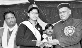 Chief Minister PK Dhumal gives away a prize to a student of Government Senior Secondary School, Kakkadyar, Hamirpur, on Friday.