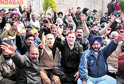 Members of the Jammu and Kashmir State Sports Council Employees Union hold a protest in support of their demands in Jammu on Friday
