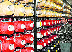A worker busy in a carpet factory in the Bari Brahmana Industrial Estate