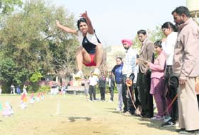 A student attempts a long jump at the annual athletics meet of the Khalsa College for Women in Ludhiana on Friday