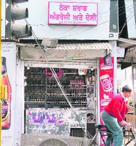 A liquor vend with a small display board in the city