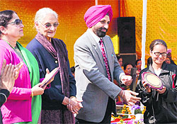 DS Cheema, dean of the College of Agricutural University, gives away a trophy on the final day of the annual athletics meet at the Khalsa College for Women in Ludhiana on Saturday