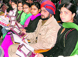 Newly appointed police constable Sant Pal Singh sits with other award winners during the annual prize distribution function at the SCD Government College in Ludhiana on Saturday