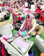 Polling parties prepare for the 4th phase of UP assembly polls, at a centre in Lucknow on Friday