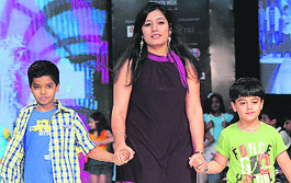 Sporting stylish apparel, children sashay down the stage