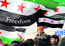 Syrians chant slogans against President Bashar al-Assad during a protest in front of the Syrian Embassy in Amman, Jordan