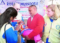A team from the Rotary Club, England, administers polio drops to a child in Mussoorie on Sunday