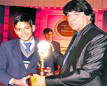 Telefilm actor Mukesh Khanna gives away a trophy to a student at DPS in Haridwar on Sunday