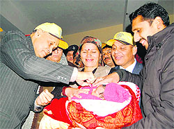 Chief Minister PK Dhumal launches the first phase of the pulse polio campaign by administering polio drops to a child in Shimla on Sunday