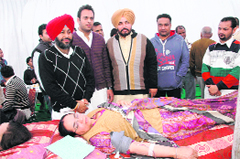A relative of late Punjab Chief Minister Beant Singh donates blood on his 88th birth anniversary in Chandigarh on Sunday. Other family members look on. 