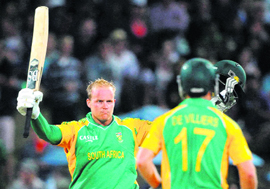 South Africas Richard Levi (L) celebrates his century against New Zealand in the Twenty20 match in Hamilton on Sunday. South Africa won by 8 wickets.