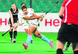 Rani Rampal hits a shot during the FIH London 2012 Olympic Hockey Qualifying tournament match against Canada at the Major Dhyan Chand National Stadium in New Delhi on Sunday. India won the match 4-1.