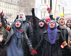 Demonstrators hold a protest against Syrian President Bashar al-Assad outside the Syrian Embassy in London on Sunday. 