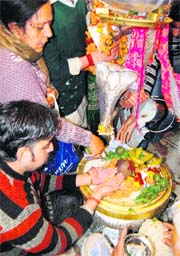 Devotees offer prayers at Shivala temple in Amritsar on Monday.