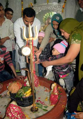 Deputy Commissioner KK Yadav offers milk on the Shivlinga at the Shiv Mandir near Mehna Chowk in Bathinda on Monday