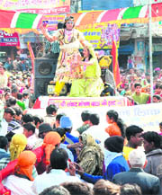Artistes dressed as Lord Shiva and Goddess Parvati perform during a shobha yatra on Shivratri in Karnal