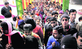 Devotees queue up to perform prayers at the historic Aap Shambu Temple on the occasion of Mahashivratri in Jammu on Monday.