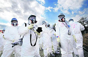 Officials from Tokyo Electric Power Co. and members of the media look at TEPCO's tsunami-crippled Fukushima Daiichi nuclear power plant on Monday. On March 11, Japan will mark the first anniversary of the deadly quake that triggred tsunami, leading to the worst nuclear disaster since Chernobyl in 1986. 
