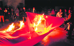 Tibetan protesters burn the Chinese flag at McLeodganj