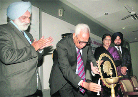 Governor NN Vohra lights the ceremonial lamp while inaugurating a national seminar on Nehrus Vision of Asia and Contemporary Asian Reality at the University of Jammu on Tuesday. 