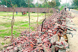 A wall of the girls' hostel of DAV College that was demolished by the Municipal Corporation in Jalandhar on Tuesday