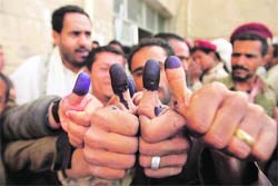 Yemeni men show their inked thumbs after casting their votes in Sanaa. 