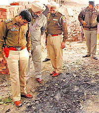 Police officials inspect the site of the blast in a gurdwara at Dashmesh Nagar in Amritsar on Wednesday
