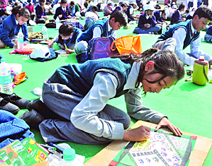 School students take part in a painting competition at India Gate as part of the Delhi police week function in New Delhi on Wednesday. 