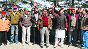 Employees of the Himachal Pradesh State Electricity Board raise slogans in support of their demands at Kumar House in Shimla on Wednesday.
