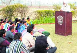 Sculptor and author Avtarjit Dhanjal interacts with students of Shri Ram College, Dalia, near Jagraon. 