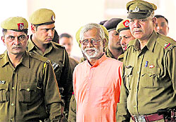Swami Aseemanand being taken to a court in Panchkula on Wednesday