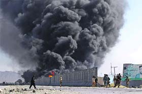 Smoke billows from a fuel tank supplying NATO troops after it was set on fire by protesters in Jalalabad