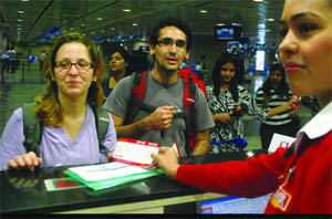 Air passengers collect their boarding cards at the Ajmeri Gate Metro Station in New Delhi on Thursday after the launch of the check-in facilities to international flyers at the station by the Airport Metro Express.