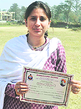 Nidhi Arora , an MA student, shows her certificate in Haridwar.