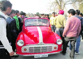 VINTAGE RALLY: Curious onlookers admire a vintage car in Una on Thursday