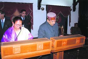 Governor Urmila Singh administers the oath of office and secrecy to Khimi Ram at the Raj Bhawan in Shimla on Thursday